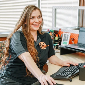 Employee at Evenflow Home & Commercial Services working on a computer